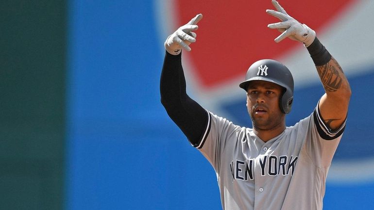 Yankees' Aaron Hicks celebrates after hitting a RBI double in...