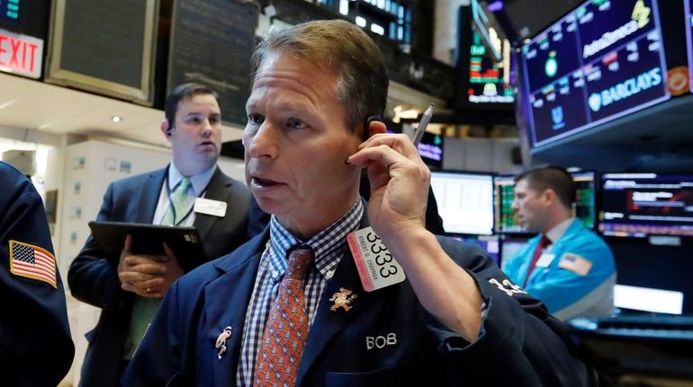 Trader Robert Charmak works on the floor of the NYSE...