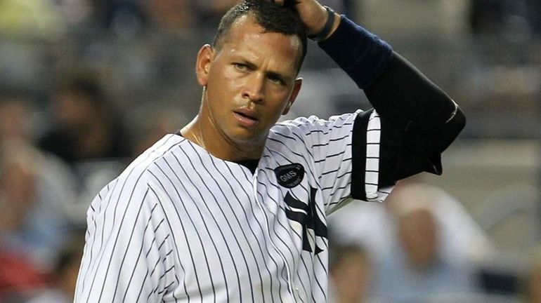 Alex Rodriguez #13 of the New York Yankees looks on...
