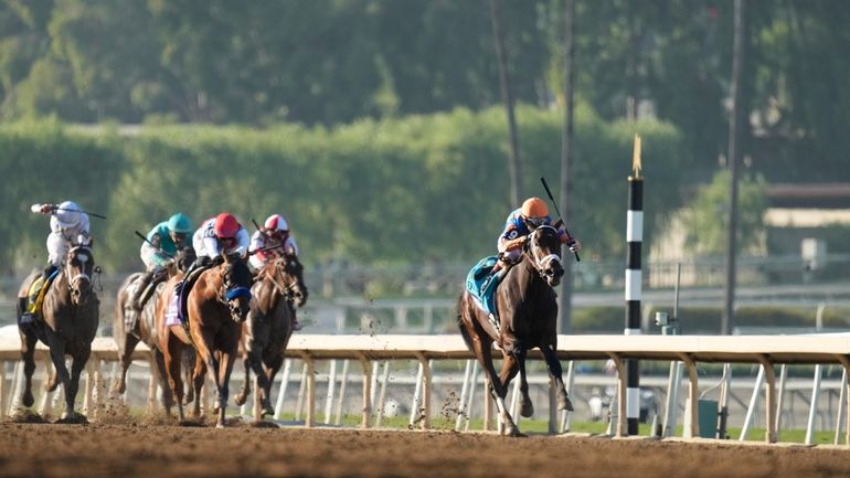 John Velazuez rides Fierceness, right, to win the Breeders' Cup...