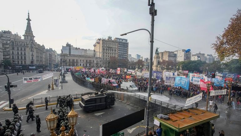 Police disperse anti-government protesters with water canons outside Congress, as...