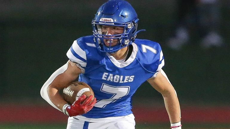 Hauppauge's Jojo Provenzano (7) runs back the opening kickoff for...