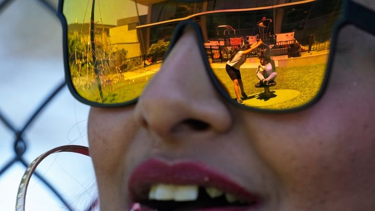Teniah Tercero watches as her daughters play at a park...
