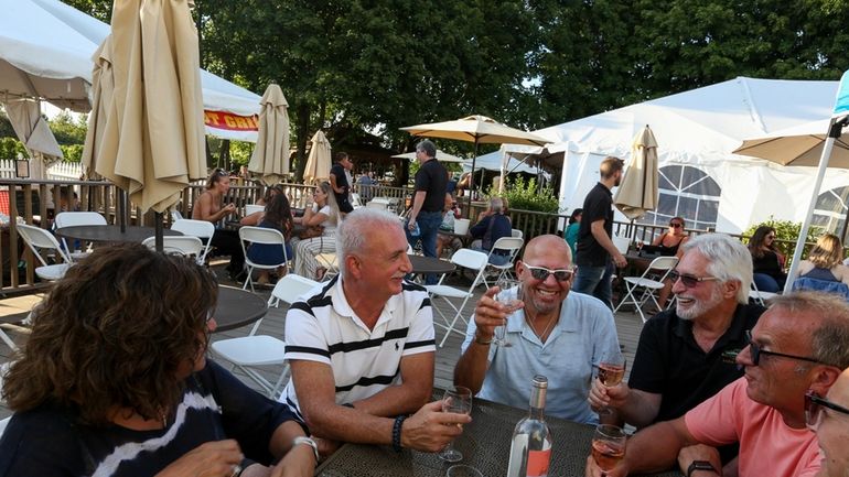 Friends share a bottle of Rose on the outdoor patio...