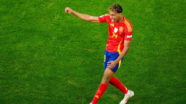 Spain's Lamine Yamal celebrates scoring his side's first goal during...