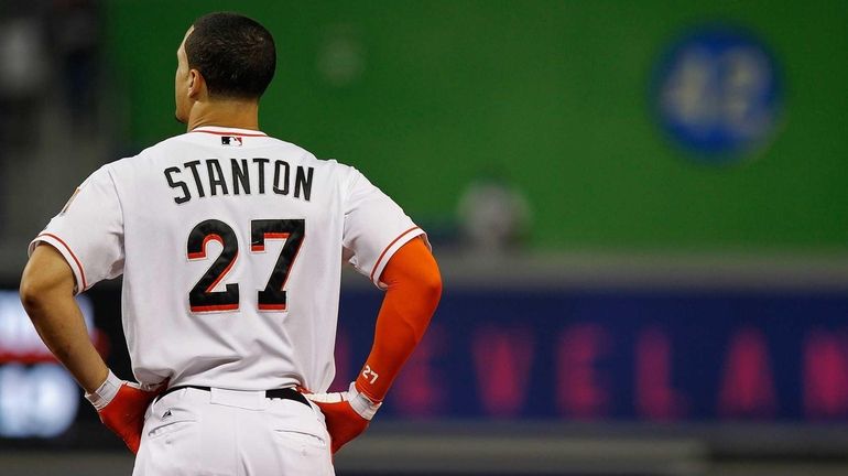 Giancarlo Stanton #27 of the Miami Marlins reacts to striking...