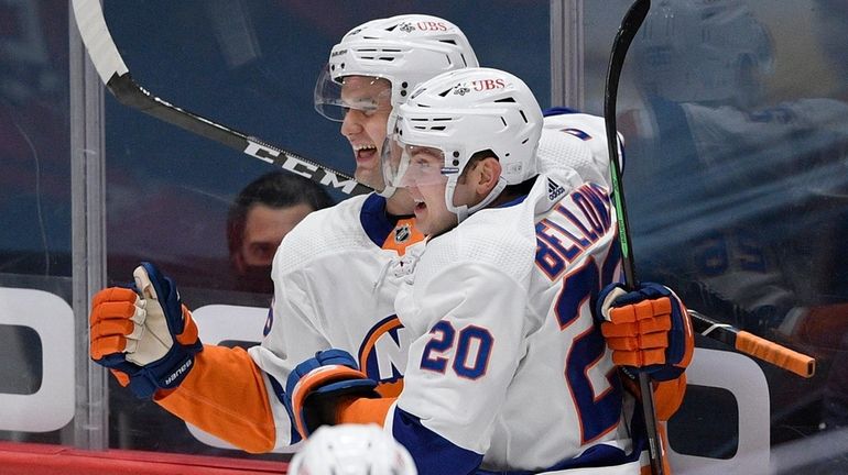 Islanders right wing Oliver Wahlstrom, left, celebrates his goal with...