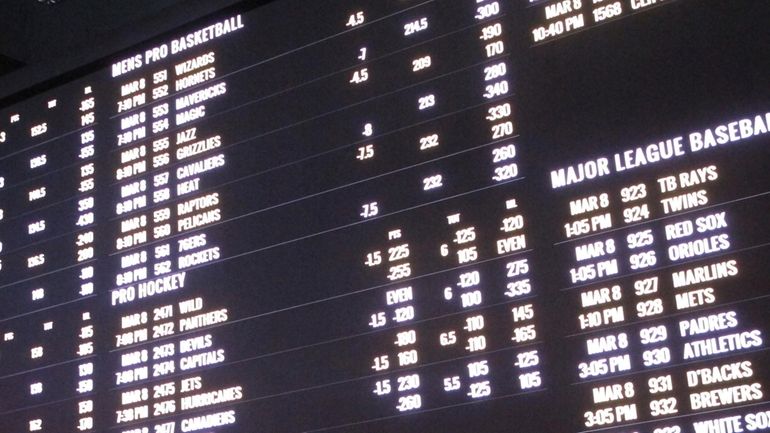 Odds for various sporting events are posted in a casino...