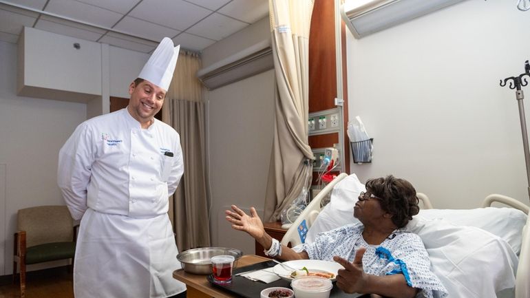 Russell Ficke, executive chef at LIJ Valley Stream, left, delivers...