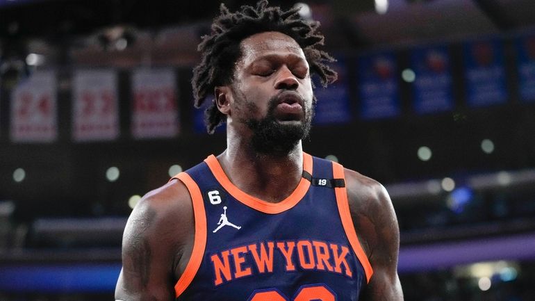 Knicks forward Julius Randle grimaces as he leaves the court...