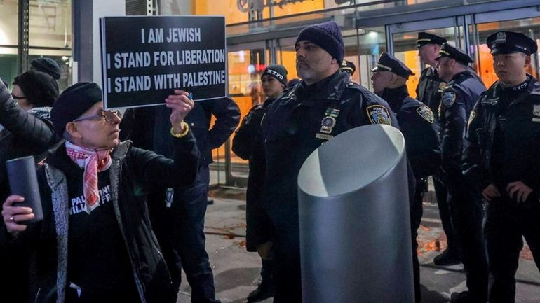 NYPD officers patrol as pro-Palestinian demonstrators march from Columbus Circle...