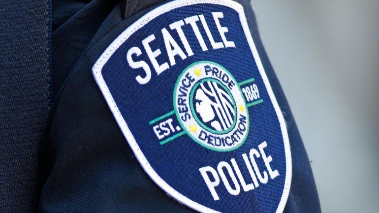 A Seattle Police Department patch is seen on an officer's...
