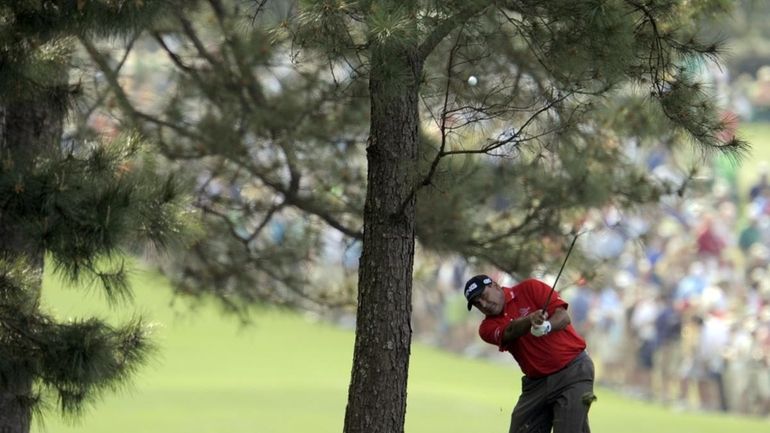 Angel Cabrera hits from the rough on the first hole...