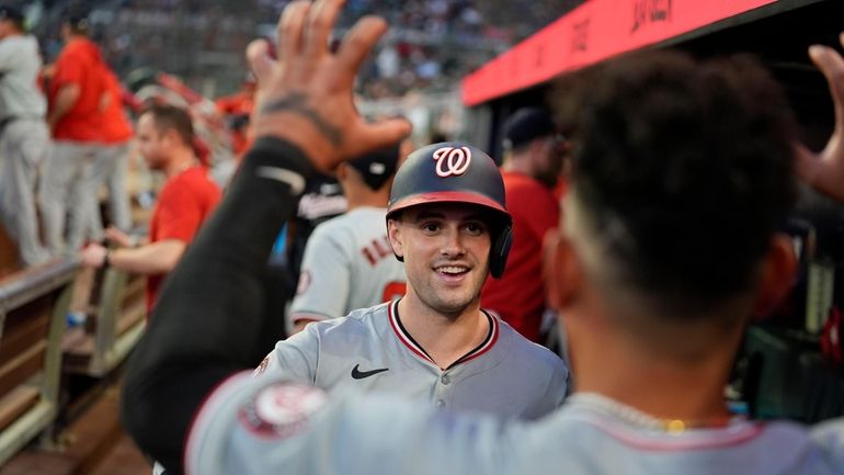 Washington Nationals' Lane Thomas (28) celebrates in the dugout after...