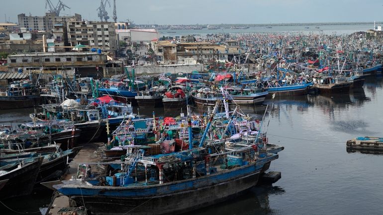 Fishing boats are anchored at a fishing harbor after weather...