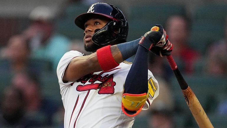 Atlanta Braves' Ronald Acuna Jr. watches his solo home run...