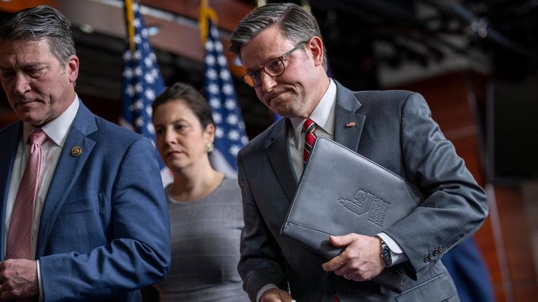 Speaker of the House Mike Johnson, R-La., right, departs after...