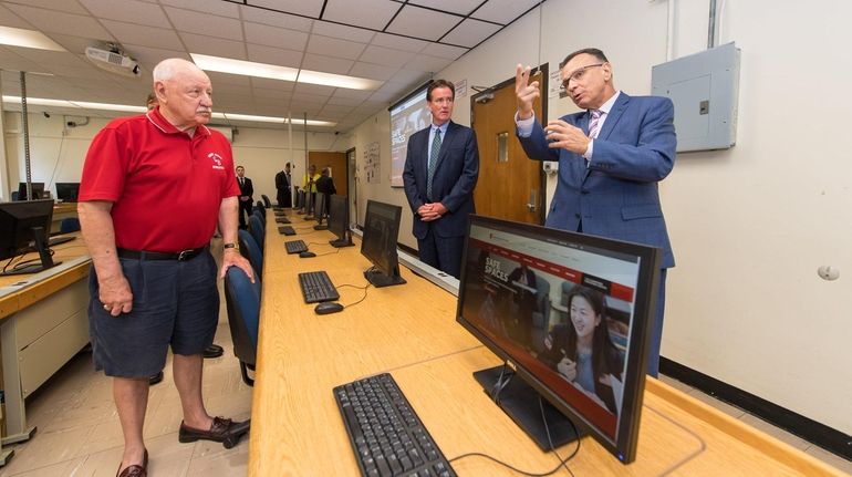 State Sens. Kenneth LaValle and John Flanagan listen to Fotis Sotiropoulos, dean of...