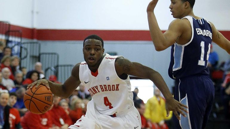 Anthony Jackson of Stony Brook drives against Maine's Justin Edwards...