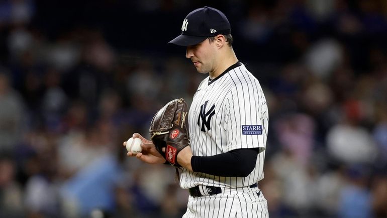 Tommy Kahnle #41 of the Yankees reacts after walking in a...