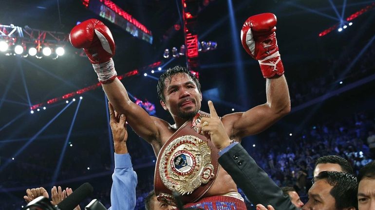 Manny Pacquiao from the Philippines wears the champion's belt after...