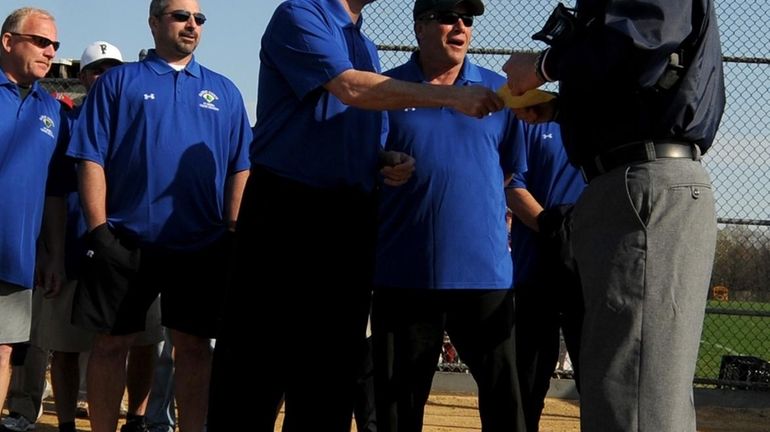 Nearly two dozen coaches from Nassau protest the suspension of...