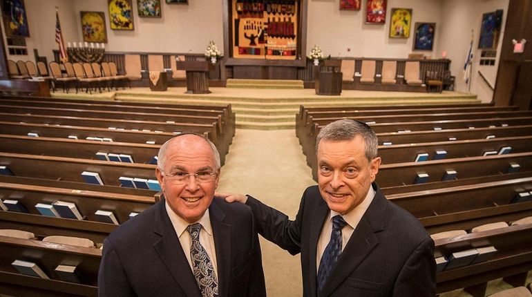 Rabbis Charles Klein (left) and Ronald Brown, stand in the...