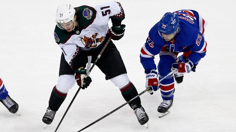 Arizona Coyotes defenseman Troy Stecher loses the puck to New...