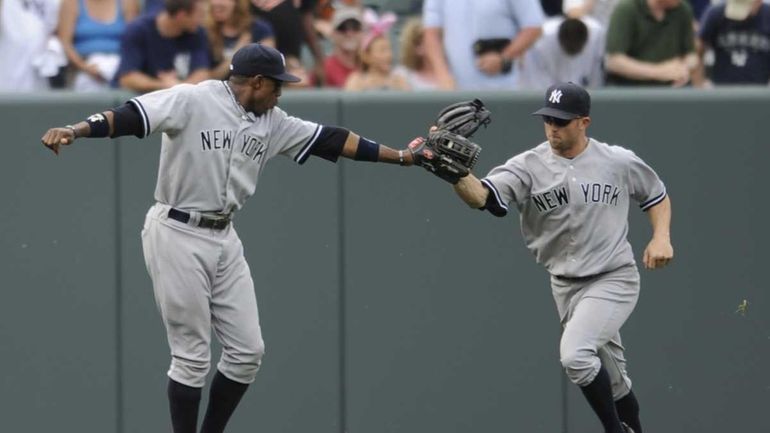 Yankees center fielder Curtis Granderson congratulates left fielder Brett Gardner...