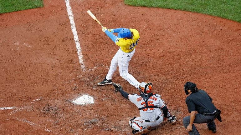 Boston Red Sox batter Triston Casas follows through on a...