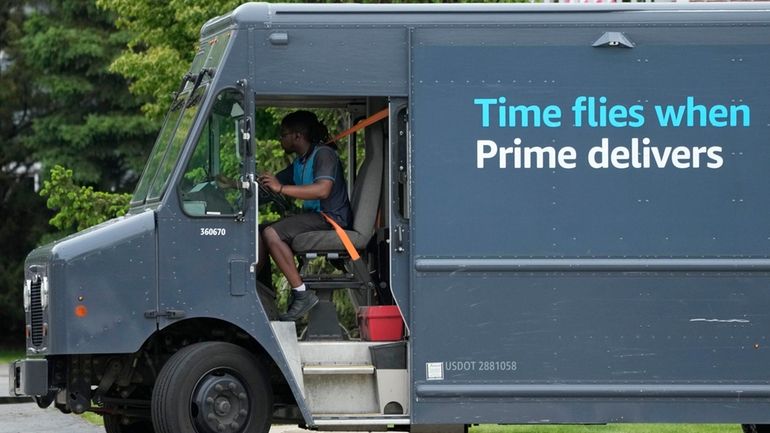 An Amazon truck makes deliveries in Wheeling, Ill., May 16,...