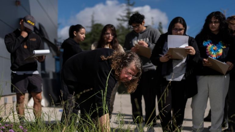 Associate professor Vered Mirmovitch leads her biology class students on...