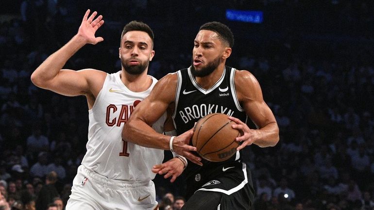 Nets guard Ben Simmons drives past Cleveland Cavaliers guard Max...