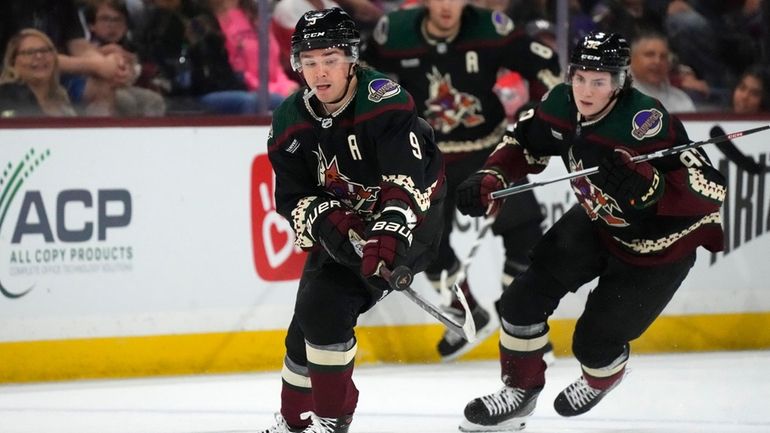 Arizona Coyotes right wing Clayton Keller (9) stops the puck...