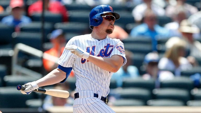 Jeff McNeil of the New York Mets follows through on his...