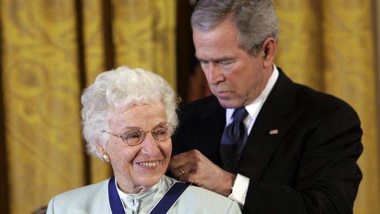 President George W. Bush, right, bestows the Presidential Medal of...