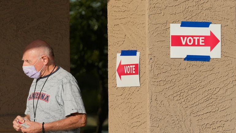 A precinct worker walks outside a voting location during the...