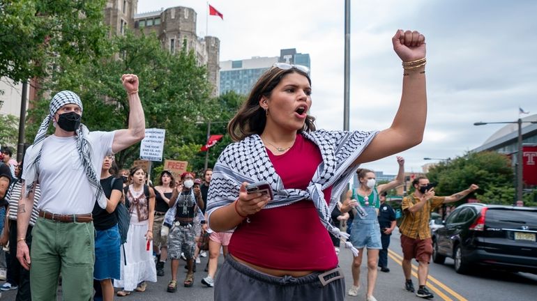 Alia Amanpour Trapp, center, reacts to car horns as she...