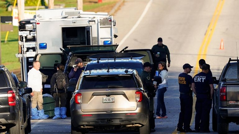 Law enforcement officers maintain their presence at Schemengees Bar and...