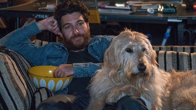 Adam Pally plays rock musician Dax with pooch Tucker in...