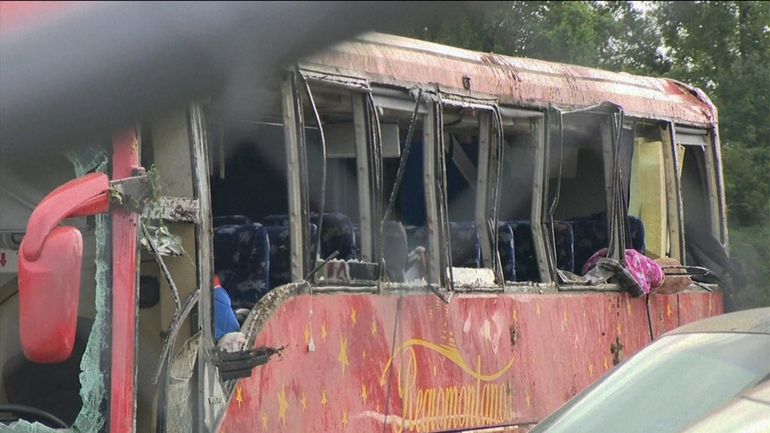 A damaged bus is shown after several people were killed...