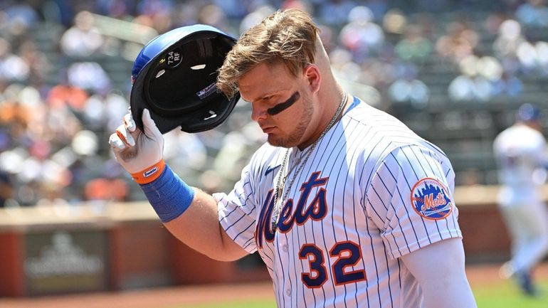 Mets designated hitter Daniel Vogelbach returns to the dugout after...