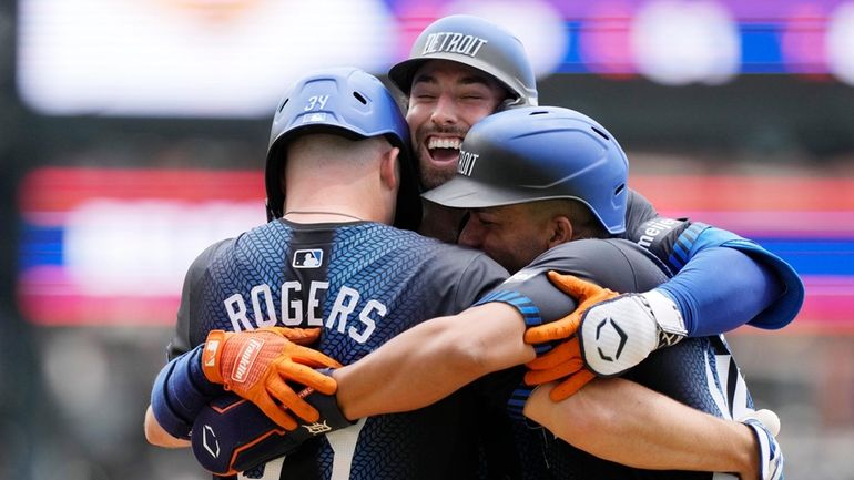 Detroit Tigers' Matt Vierling is greeted at home plate by...