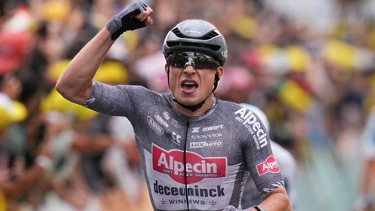 Belgium's Jasper Philipsen celebrates as he crosses the finish line...