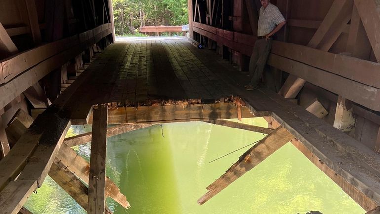 A hole is seen after a loaded dump truck plummeted...