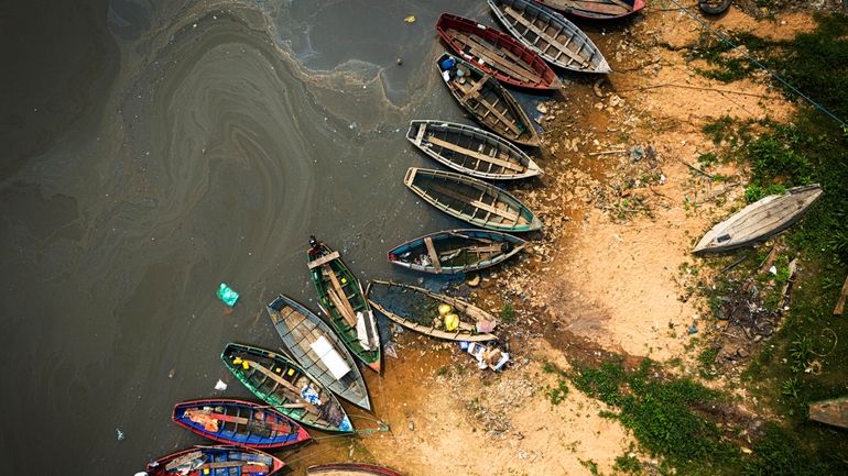 Fishing boats sit on the shore of the Paraguay River...