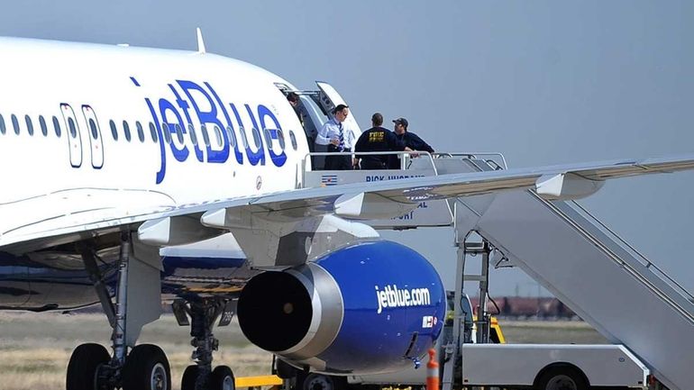 Authorities board JetBlue Flight 191, which was headed from New...