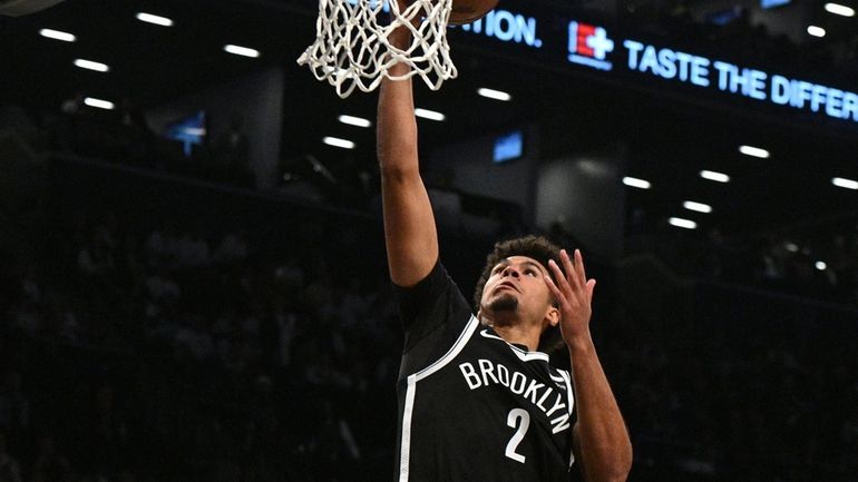 Nets forward Cam Johnson goes u for a layup against...