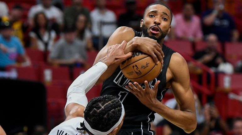 Nets forward Mikal Bridges is fouled by Heat guard Gabe Vincent...