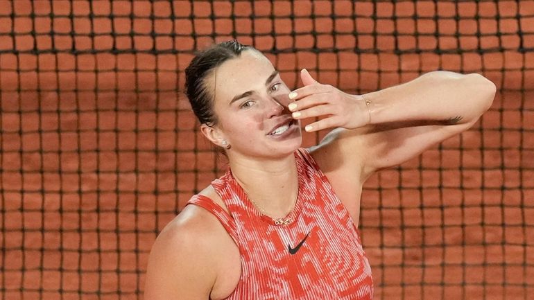 Aryna Sabalenka of Belarus blows a kiss to cheering tennis...